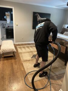 Poseidon Carpet Cleaning professional with carpet extractor